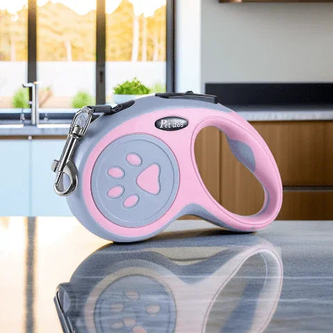laisse enrouleur pattes de chien rose